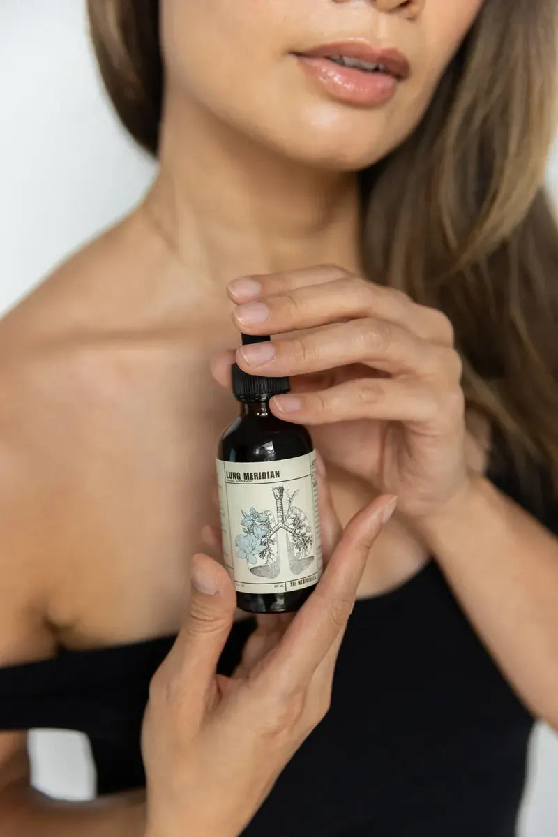 Lung Meridian bottle held in the hand, label facing out