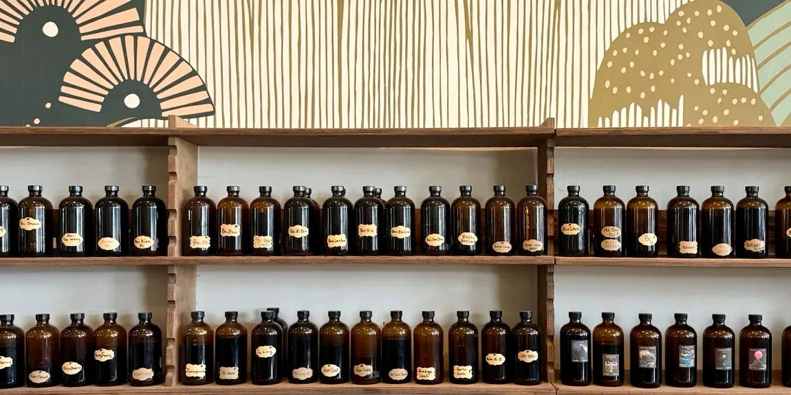 The Zoi tincture wall: two shelves of amber bottles with handwritten labels